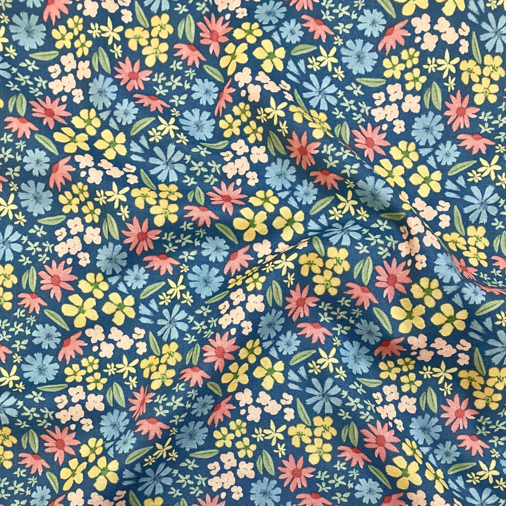 100% cotton quilting fabric — Colourful floral pattern on blue. 43/44in width.