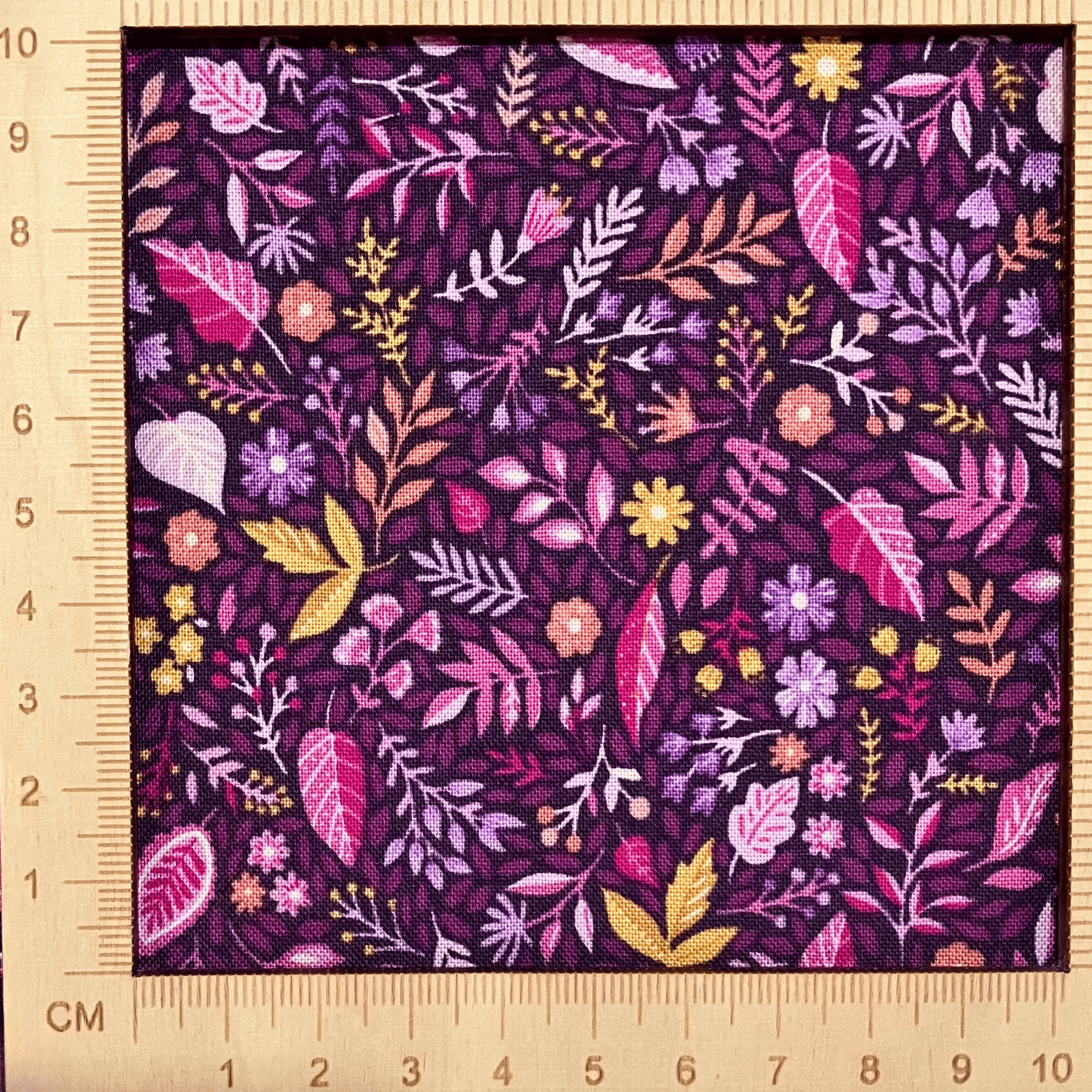 4"x4" scale — 100% cotton quilting fabric — pink, purple & yellow tropical florals on dark purple. 44in width.