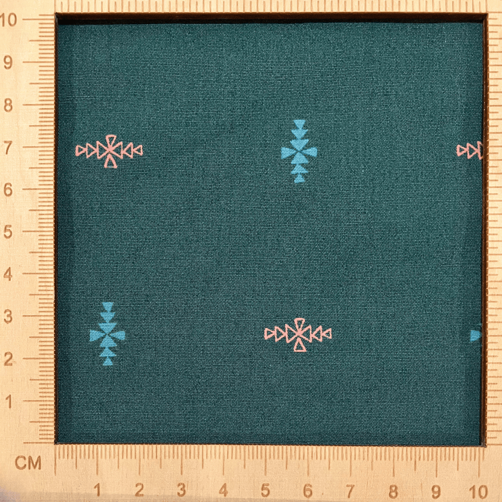 4"x4" scale — 100% cotton quilting fabric — blue & orange triangles in diamond formations on dark blue-green. 44in width.