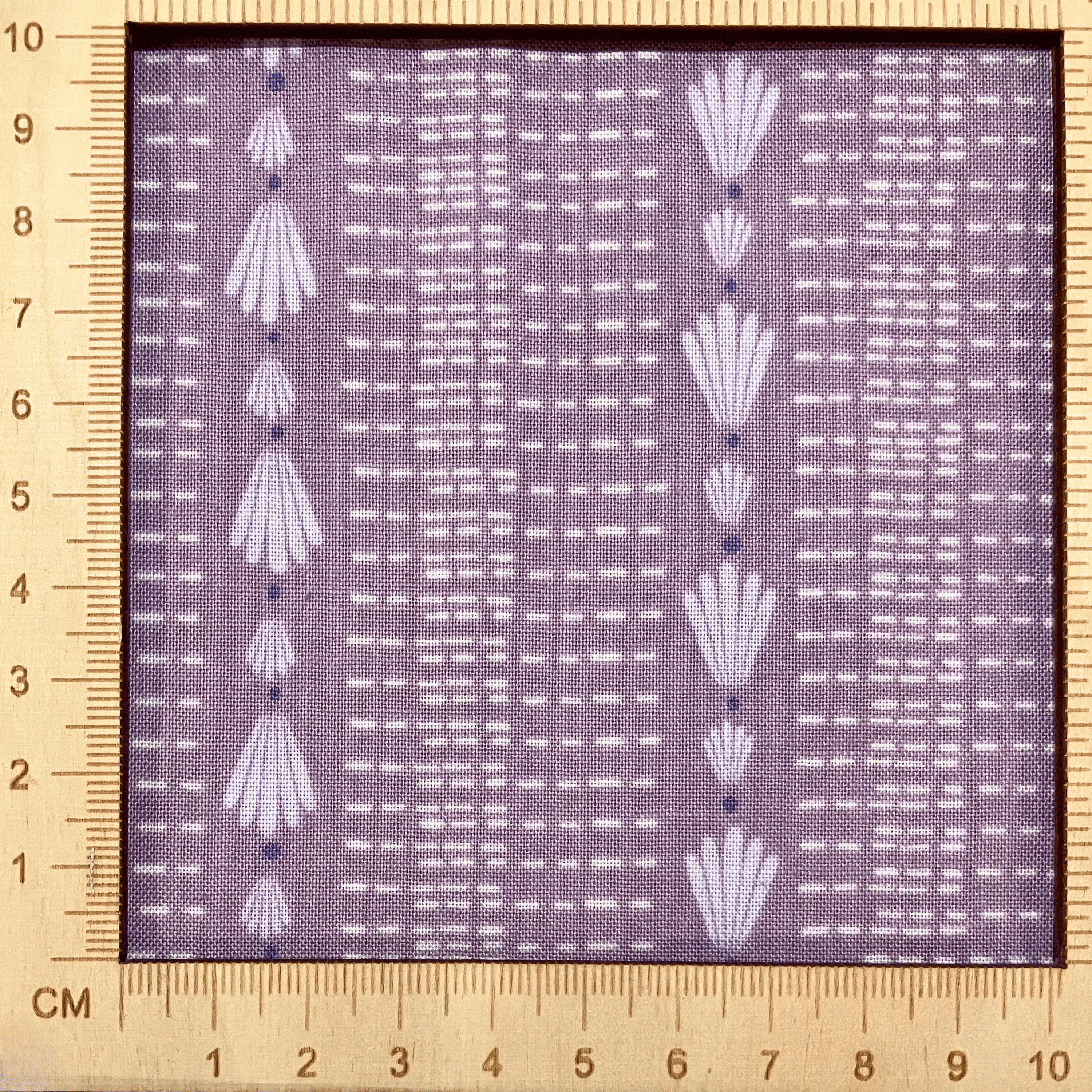 4"x4" scale — 100% cotton quilting fabric — repeated shell & dash lines on grey-purple. 44/45in width.