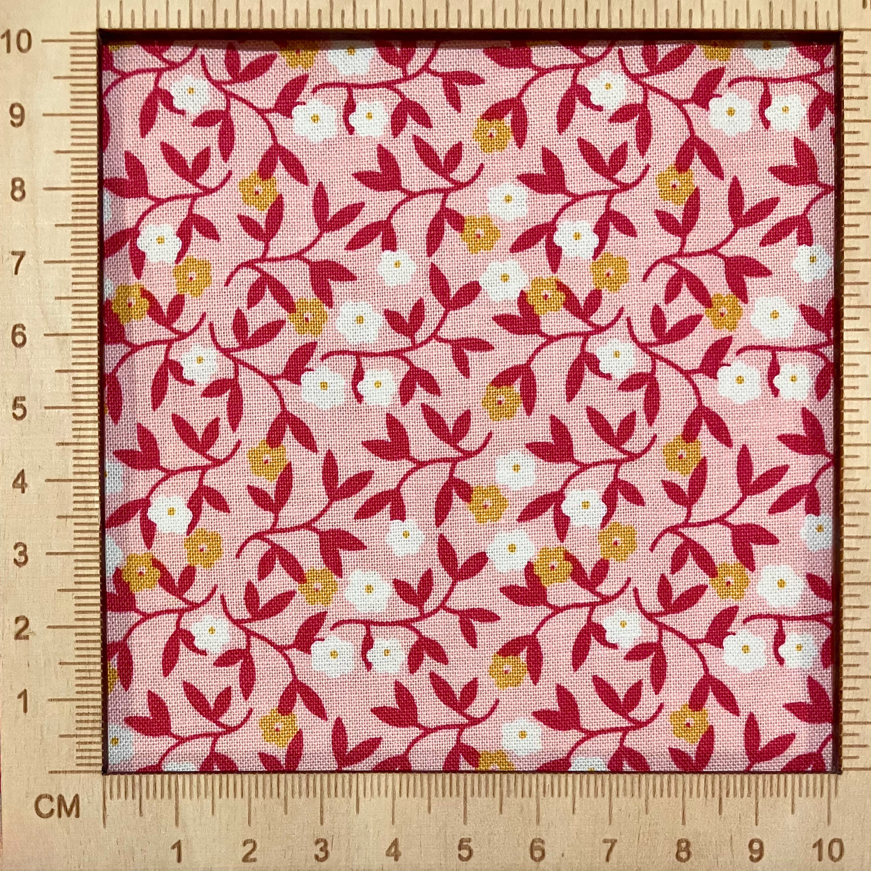 4"x4" scale — 100% cotton quilting fabric — small white & orange flowers on light coral. 43/44in width.