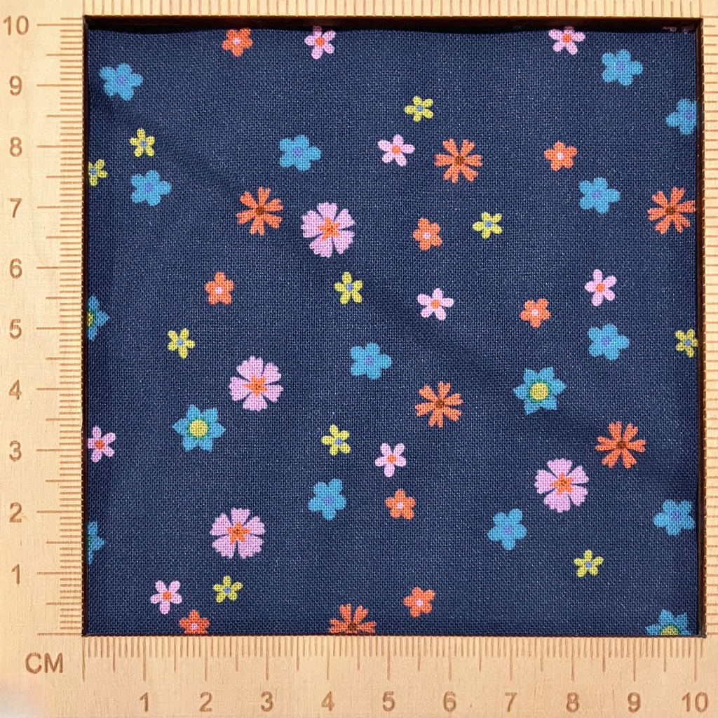 4"x4" scale — 100% cotton quilting fabric — pink, orange, green & blue flowers on dark blue. 43/44in width.