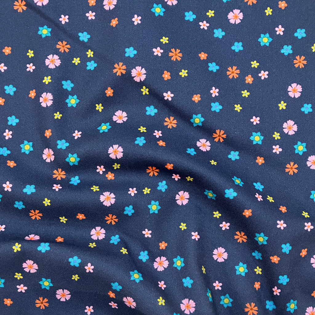 100% cotton quilting fabric — pink, orange, green & blue flowers on dark blue. 43/44in width.