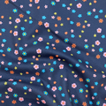100% cotton quilting fabric — pink, orange, green & blue flowers on dark blue. 43/44in width.