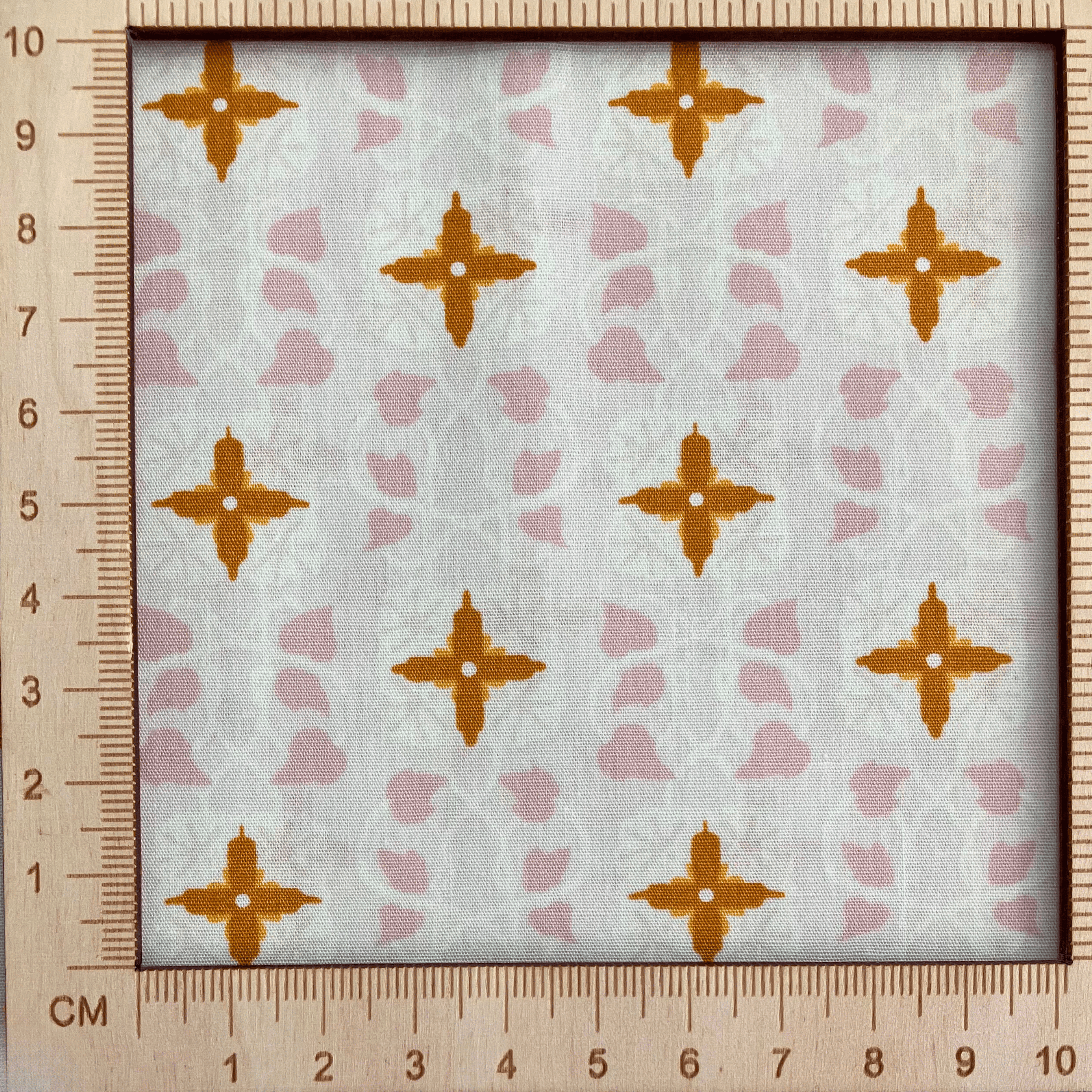 4"x4" scale — 100% cotton quilting fabric — geometric mosaic-inspired pattern on cream. 44/45in width.