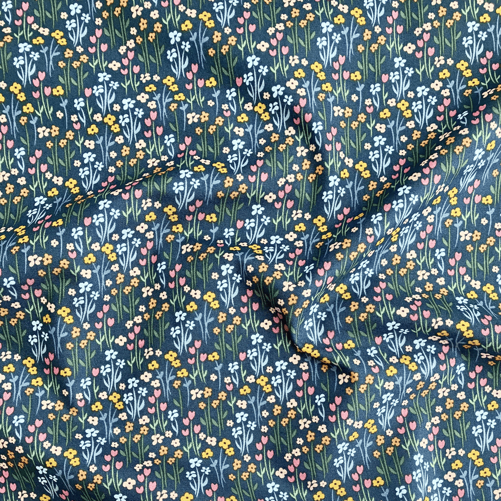 100% cotton quilting fabric — multicoloured flowers with stems on dark green-grey. 43/44in width.