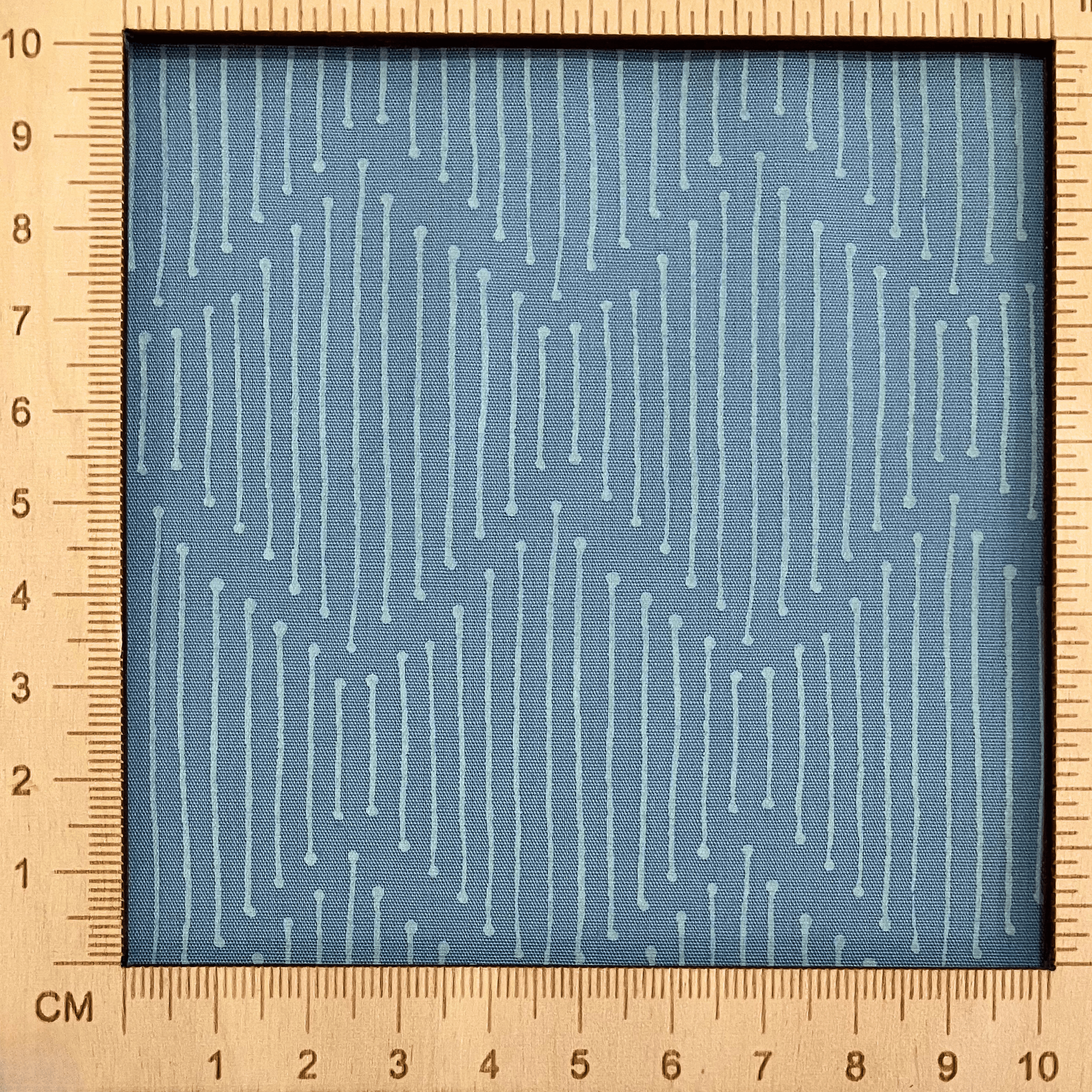 4"x4" scale — 100% cotton quilting fabric — broken white lines on soft grey-blue. 43/44in width.