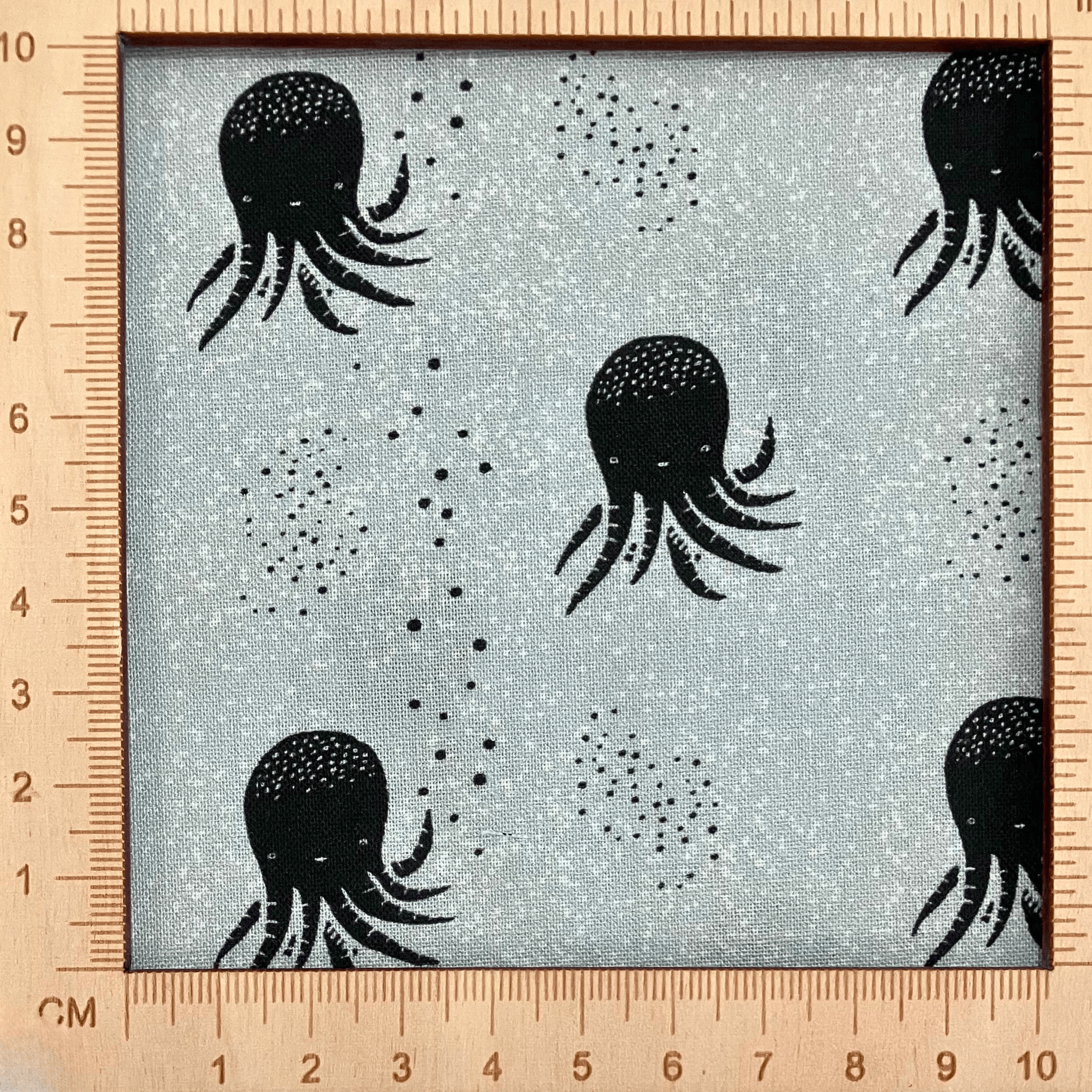 4"x4" scale — 100% cotton quilting fabric — black & white octopus on blue-grey. 43/44in width.