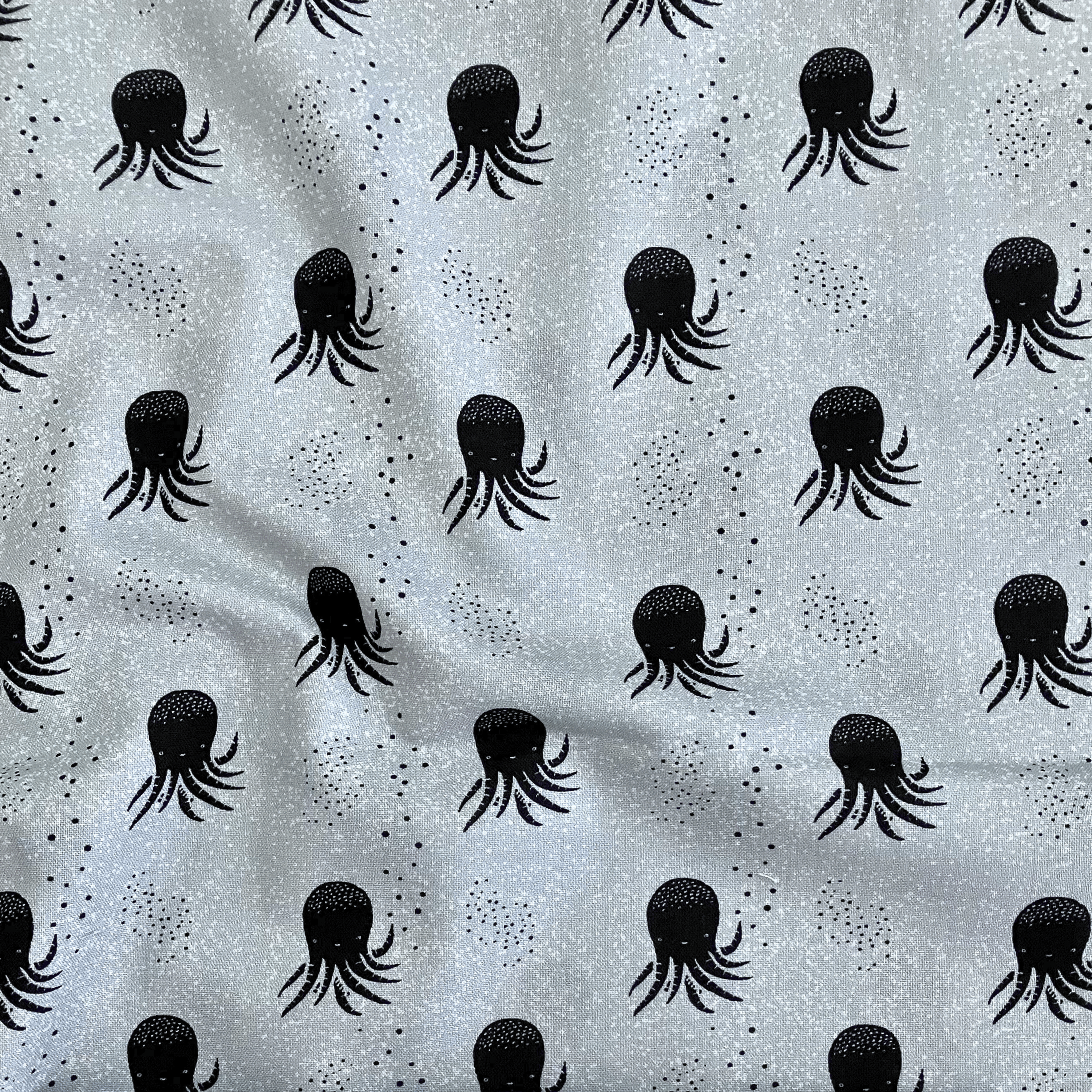 100% cotton quilting fabric — black & white octopus on pale blue-grey. 43/44in width.