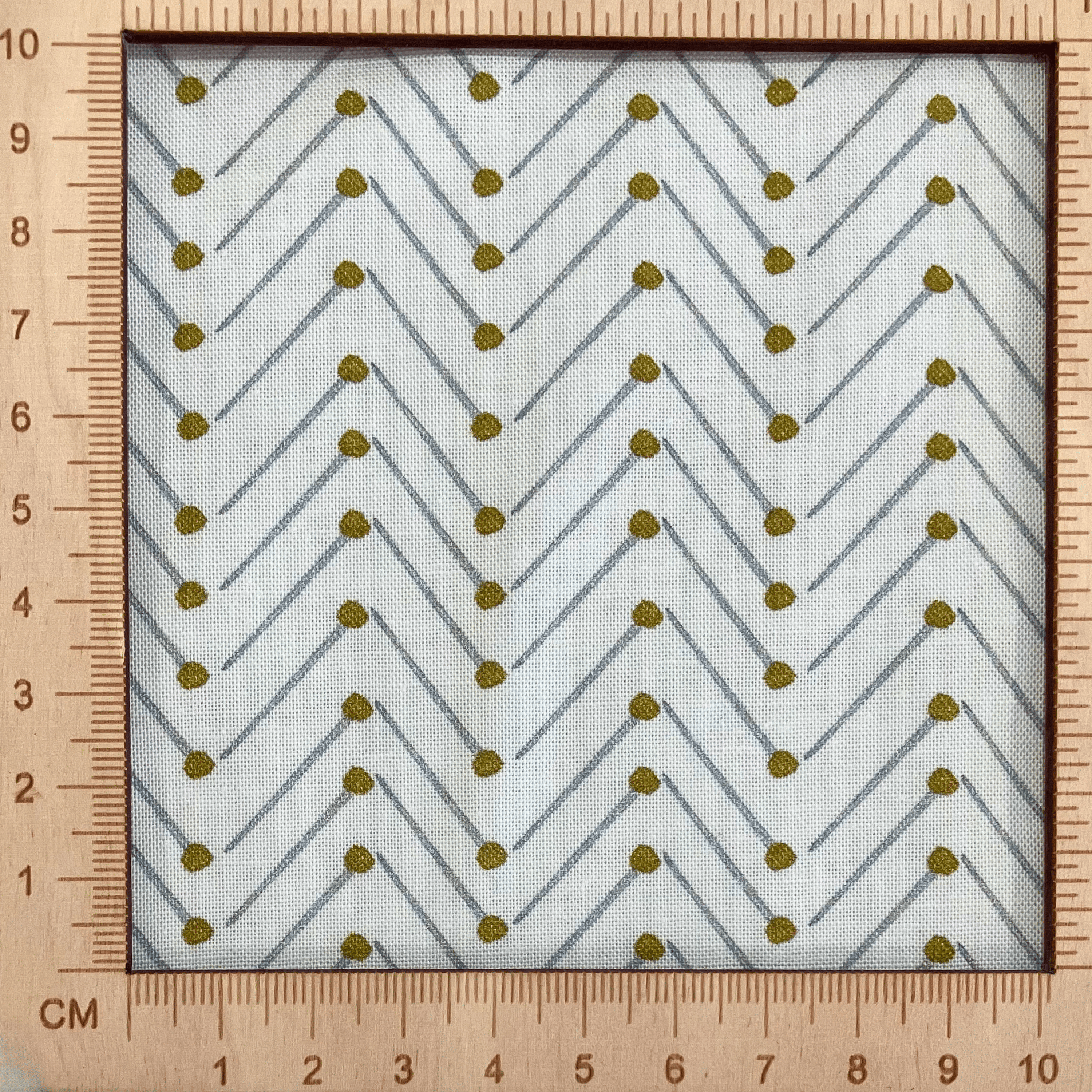 4"x4" scale — 100% cotton quilting fabric — grey & gold pins in chevron pattern on white. 44in width.
