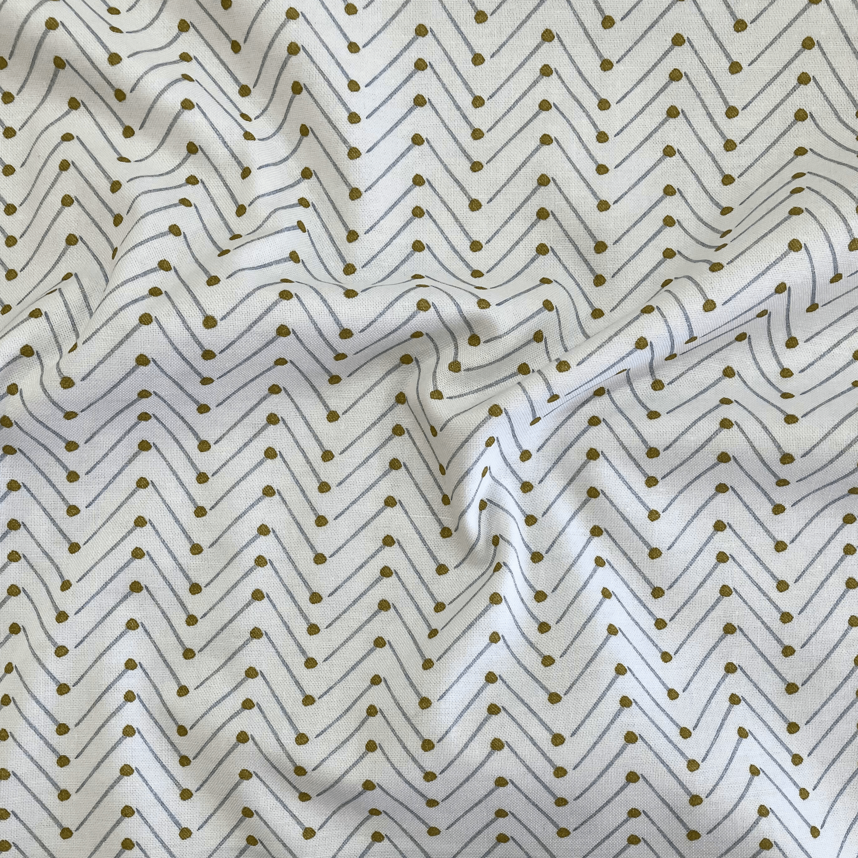 100% cotton quilting fabric — grey & gold pins in chevron pattern on white. 44in width.