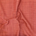 Plaid Sketch quilting cotton — hand-drawn grid check in deep cranberry on a warm salmon pink background. Phoebe Fabrics Wintry collection, 43/44″ wide. Canadian.