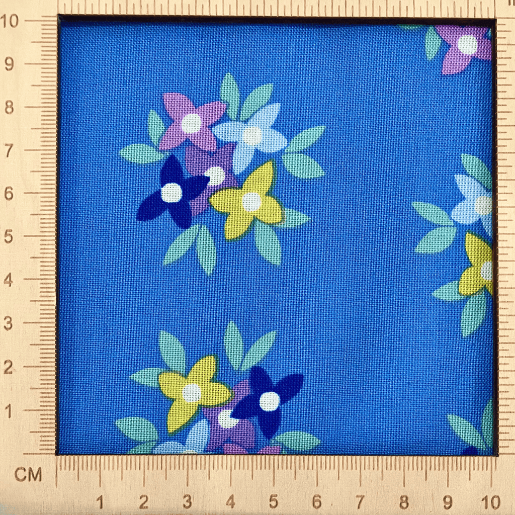 4"x4" scale — 100% cotton quilting fabric — bold floral pattern on blue. 44/45in width.