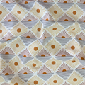 100% cotton quilting fabric — burnt orange sun-like circles in diamond pattern on white. 43/44in width.