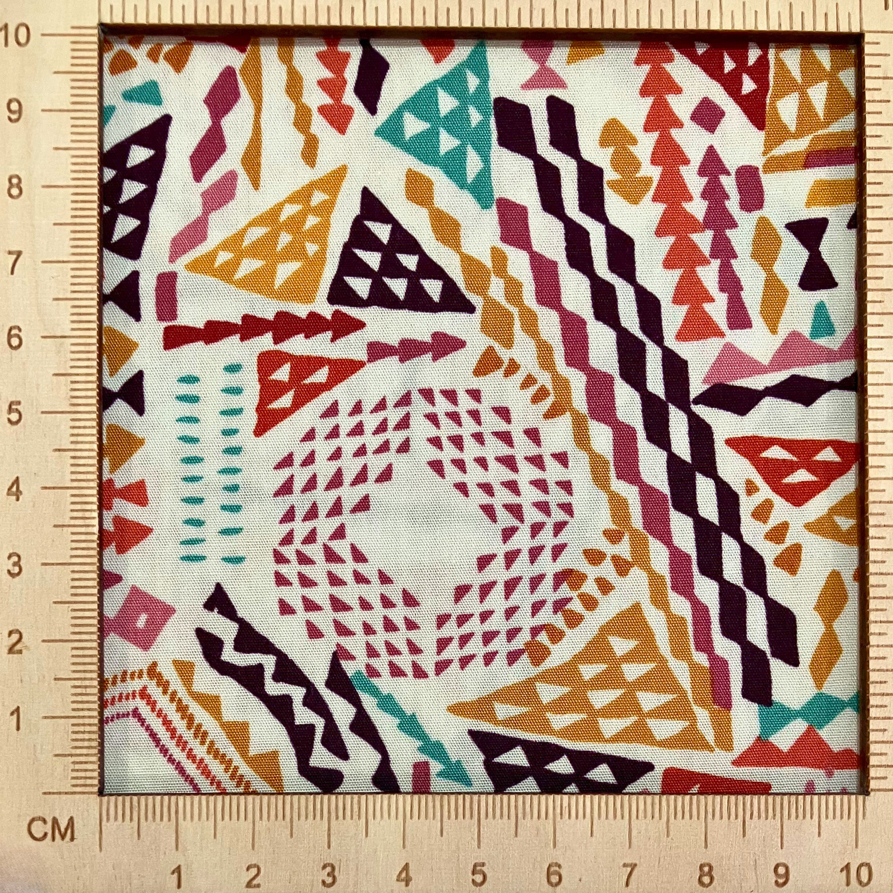 4"x4" scale — 100% cotton quilting fabric — burgundy, redwood, amber & denim triangles on beige. 44in width.