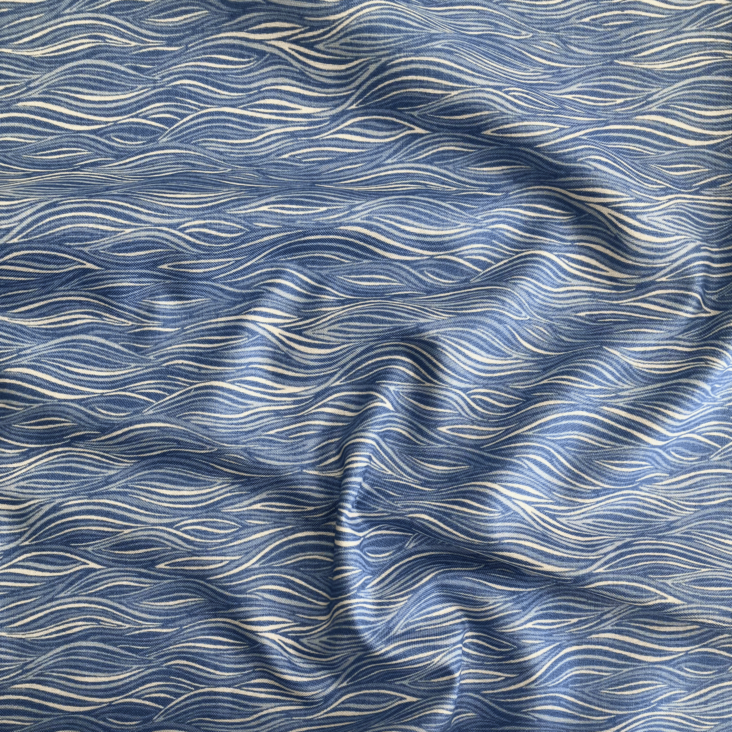 100% cotton quilting fabric — blue wavy ripple pattern. 44/45in width.