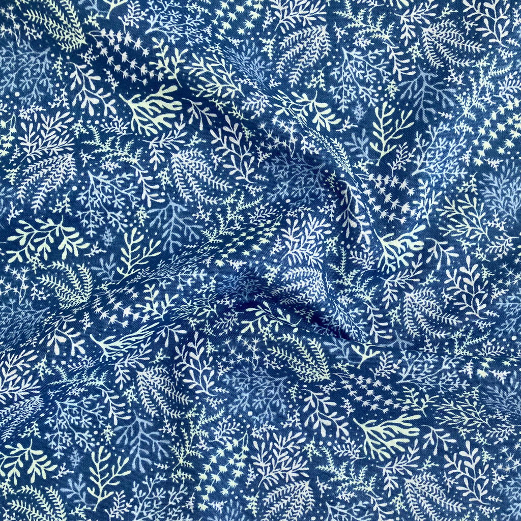 100% cotton quilting fabric — white & pale green seaweed pattern on blue. 44/45in width.