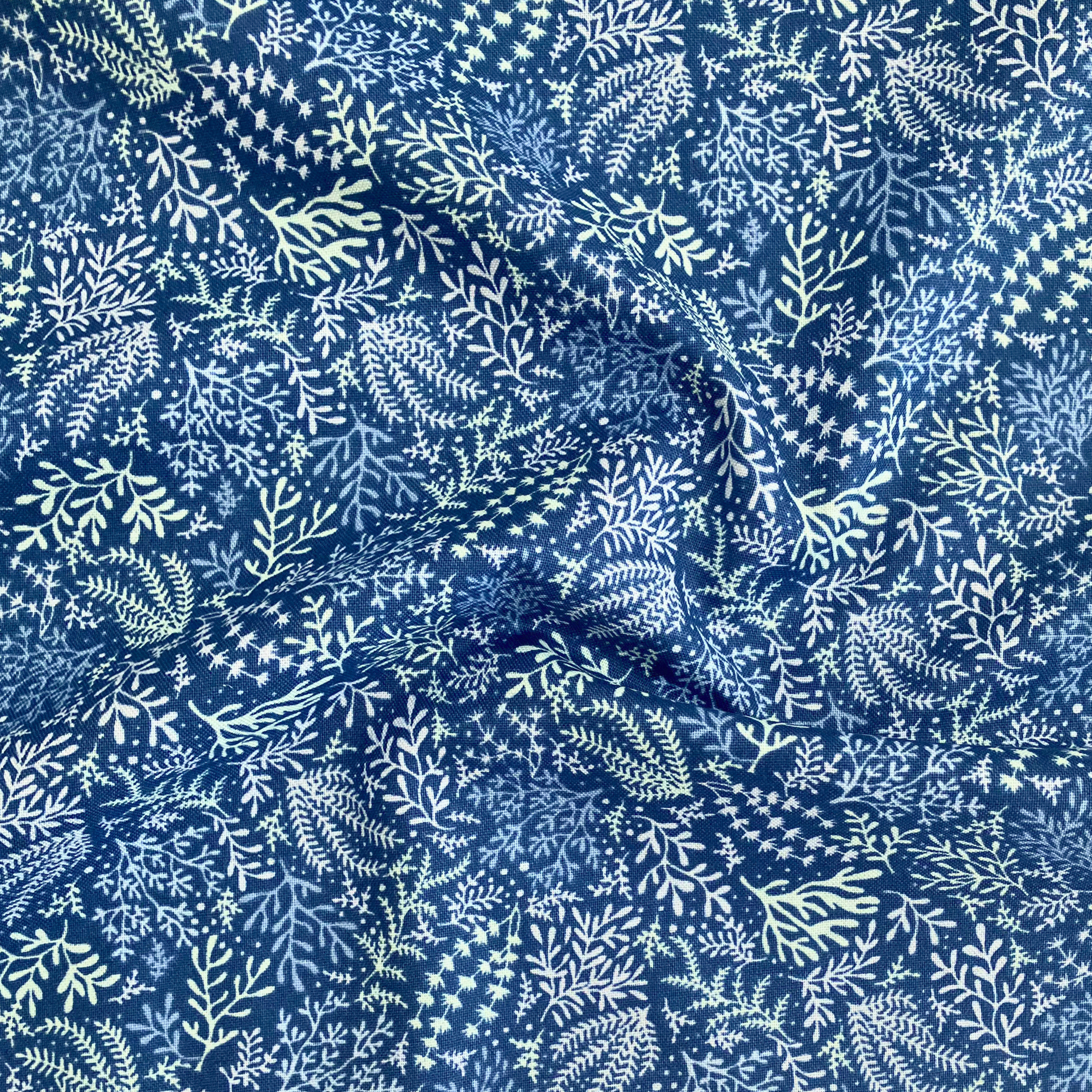 100% cotton quilting fabric — white & pale green seaweed pattern on blue. 44/45in width.