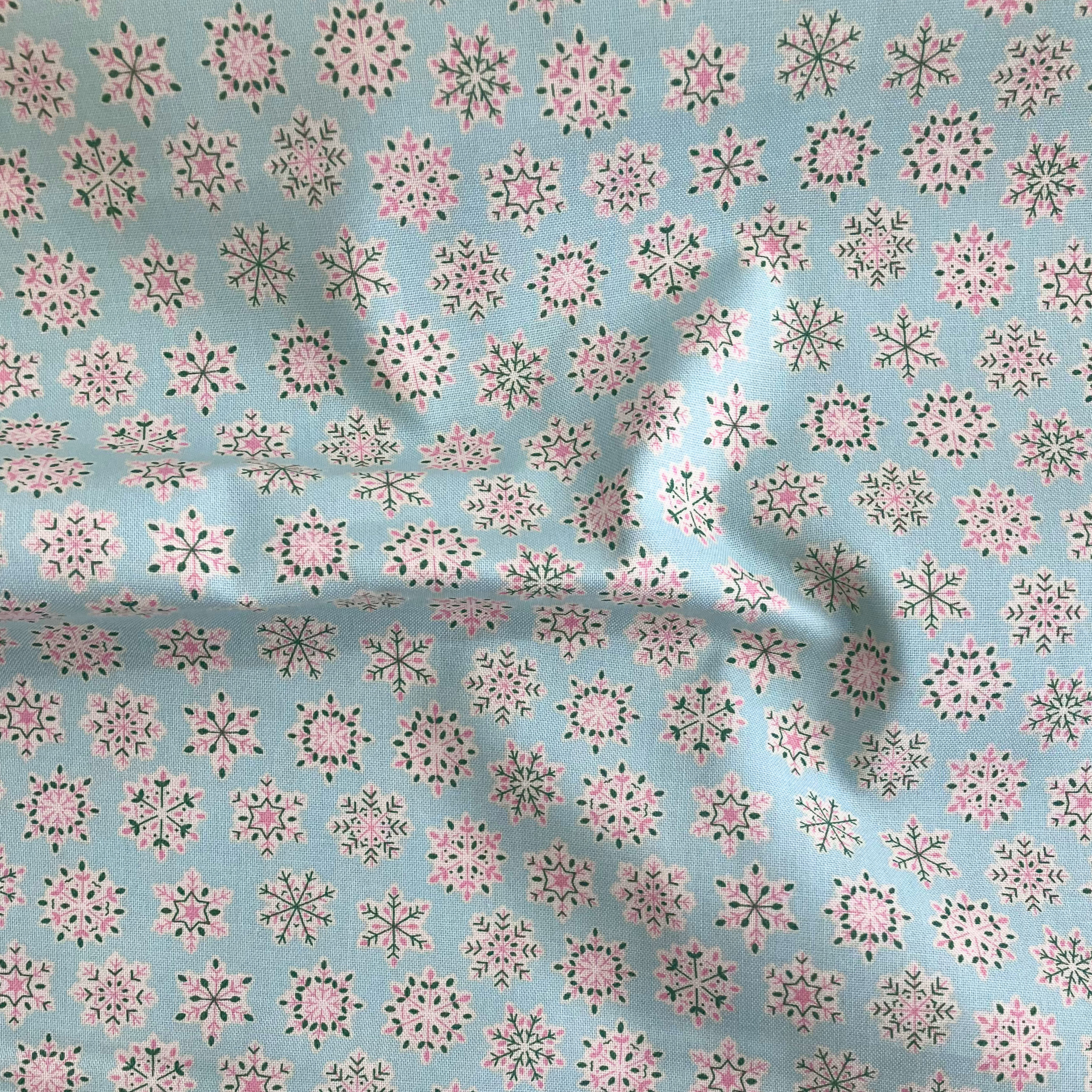 Liberty Fabrics Lasenby cotton — Light pink and green geometric snowflake pattern on mint. Festive Greetings collection. 44/45in width.