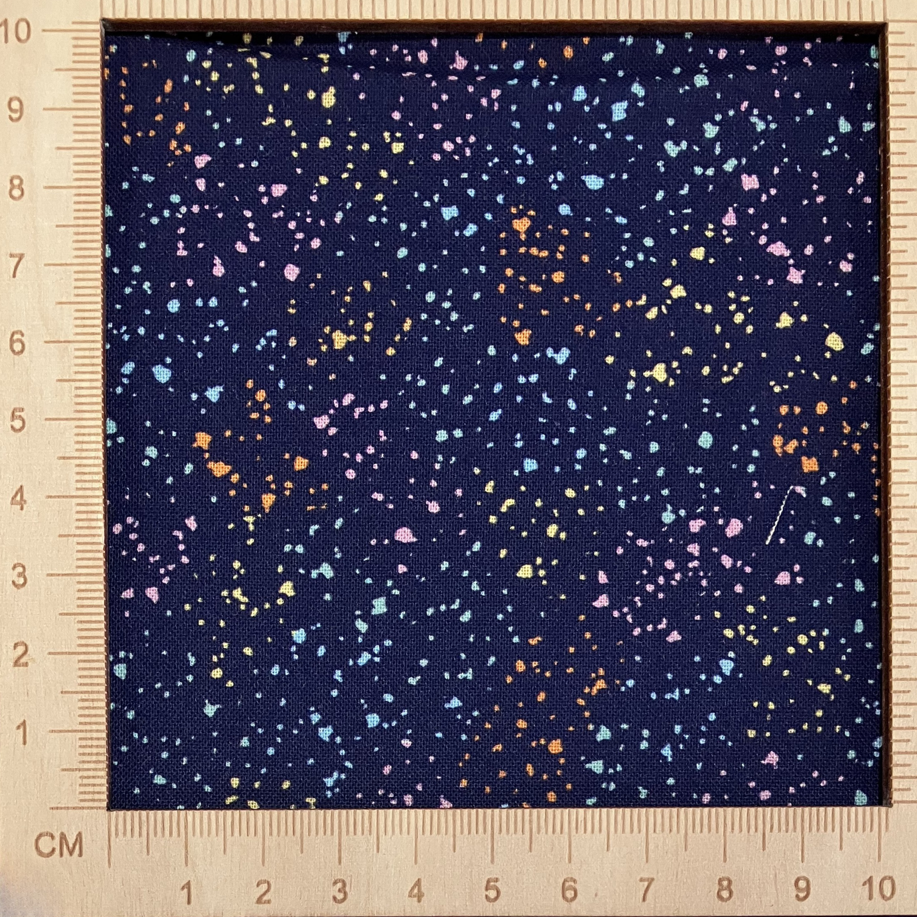 4"x4" scale — 100% cotton quilting fabric — multicolour speckles on navy blue. 44/45in width.