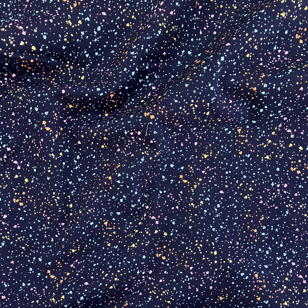 100% cotton quilting fabric — multicolour speckles on navy blue. 44/45in width.