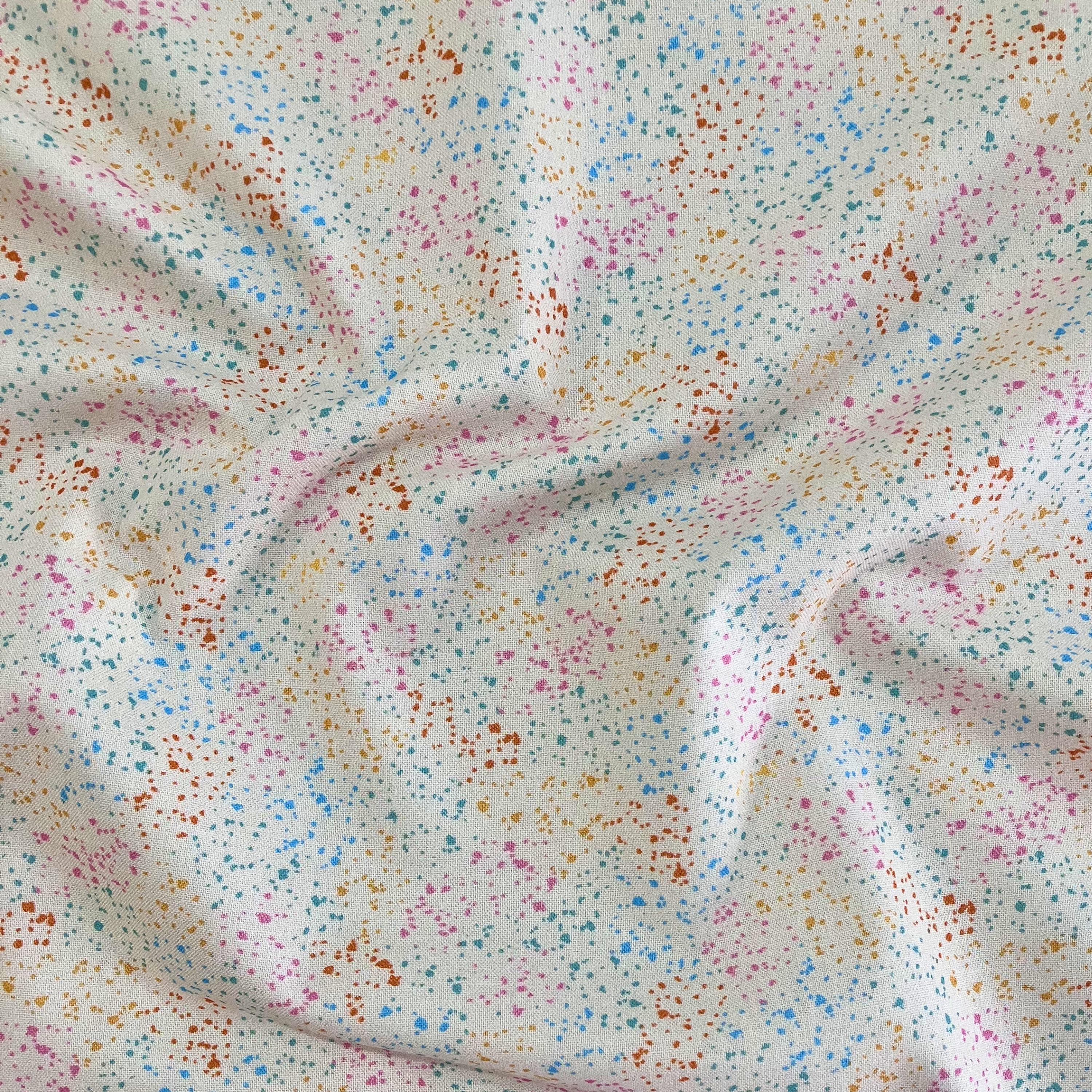 100% cotton quilting fabric — multicolour speckles on cream. 44/45in width.