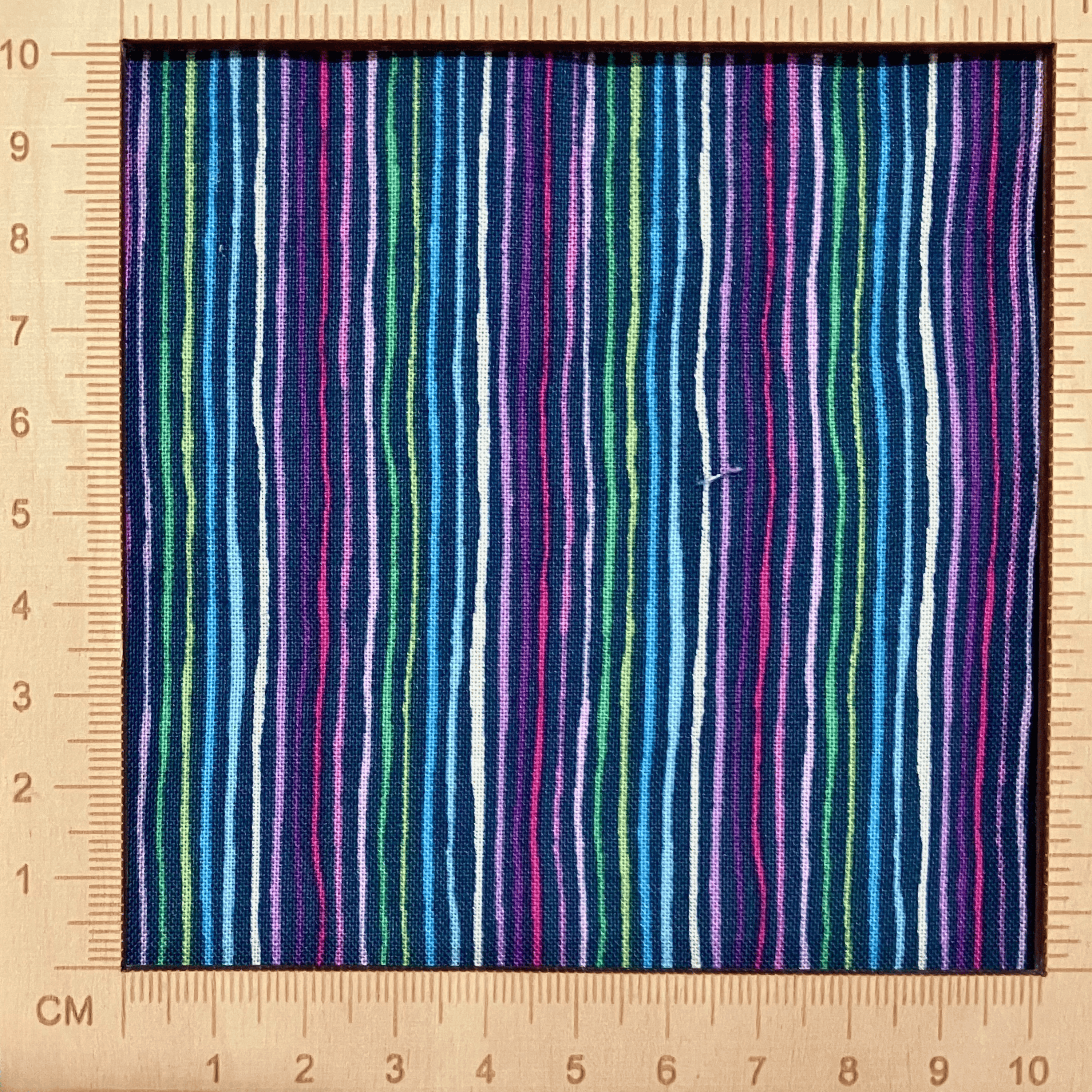 4"x4" scale — 100% cotton quilting fabric — multicoloured stripes on dark navy. 43/44in width.
