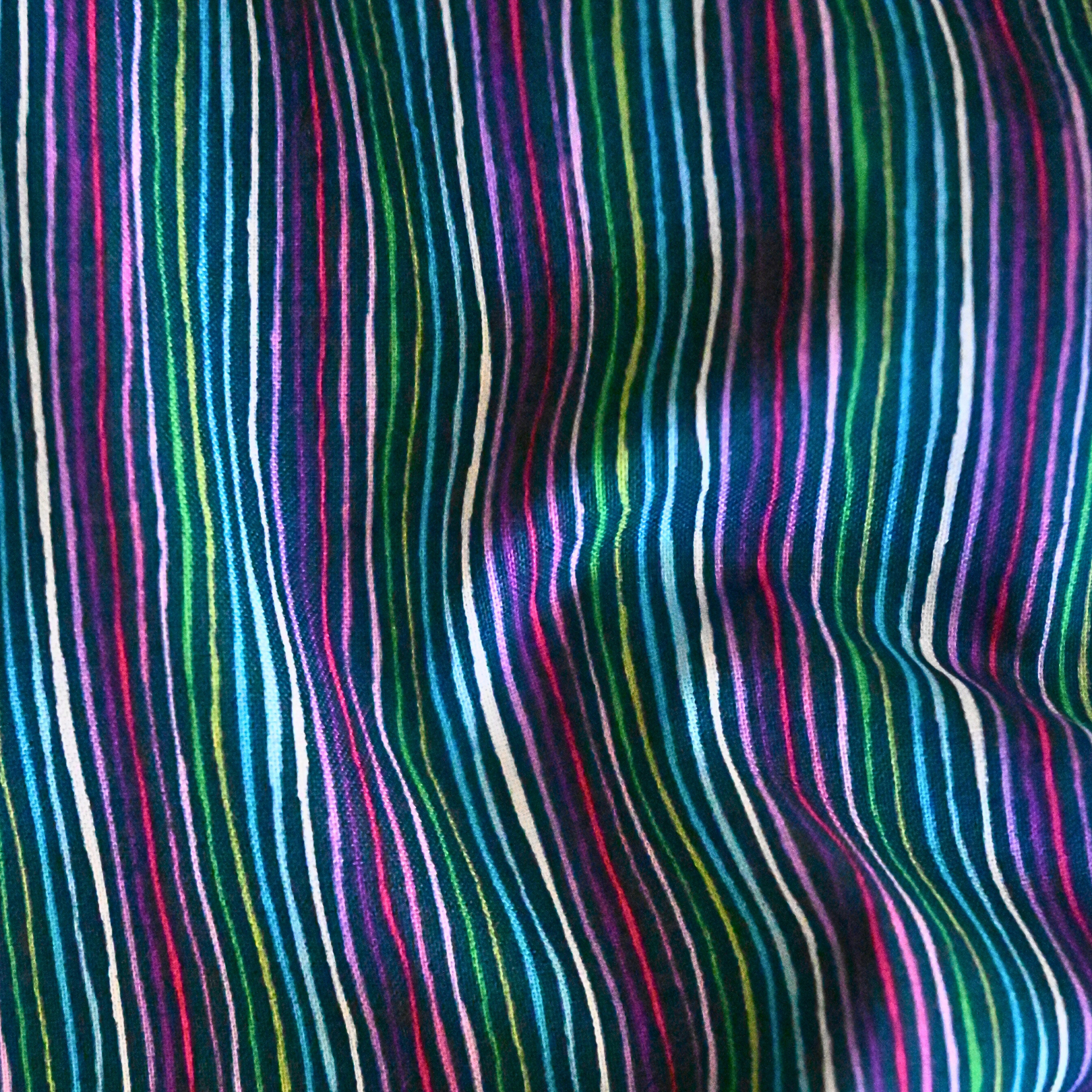 100% cotton quilting fabric — multicoloured stripes on dark navy. 43/44in width.