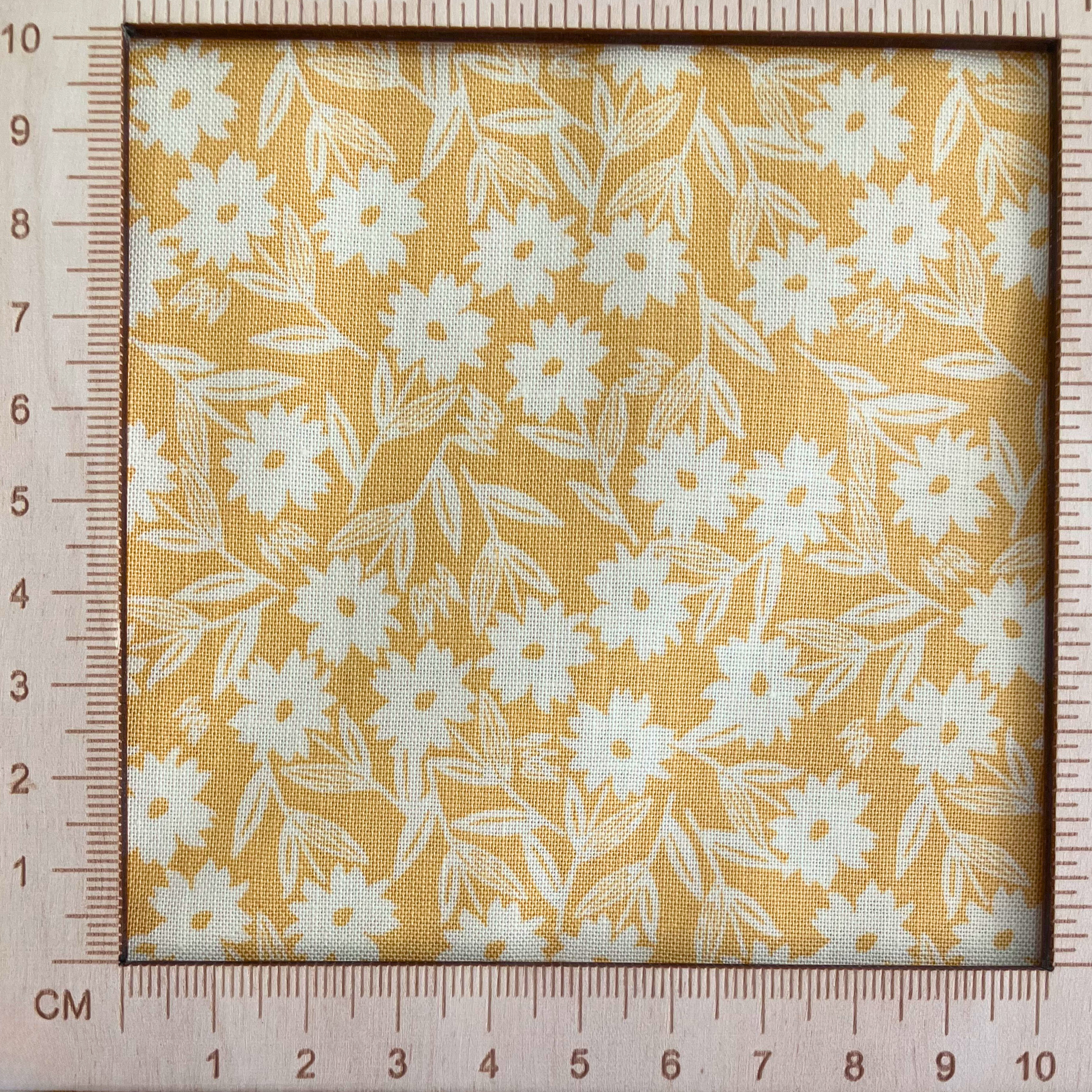 4"x4" scale — 100% cotton quilting fabric — white florals on yellow. 44/45in width.
