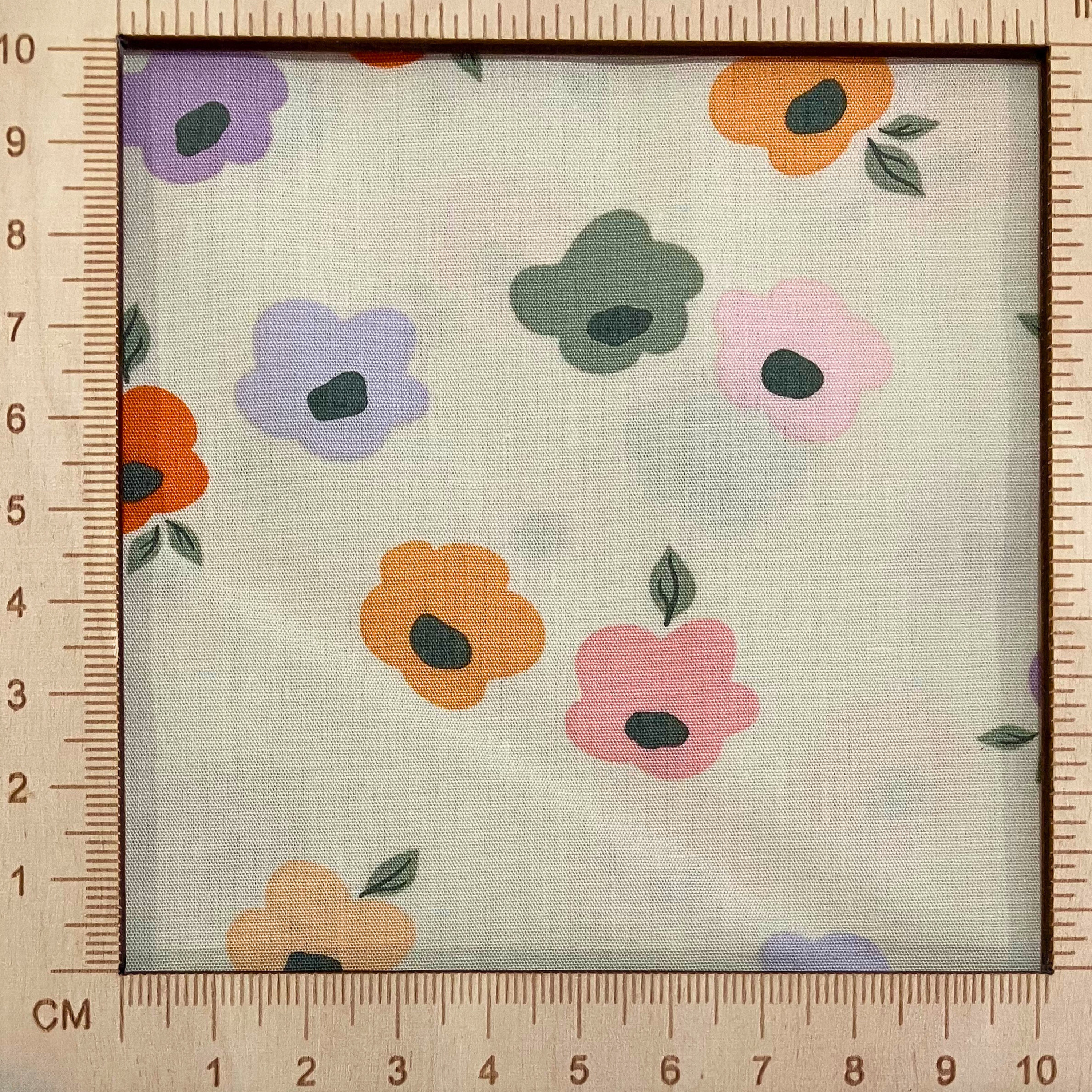 4"x4" scale — 100% cotton quilting fabric — Pastel-coloured flowers on cream. 44/45in width.