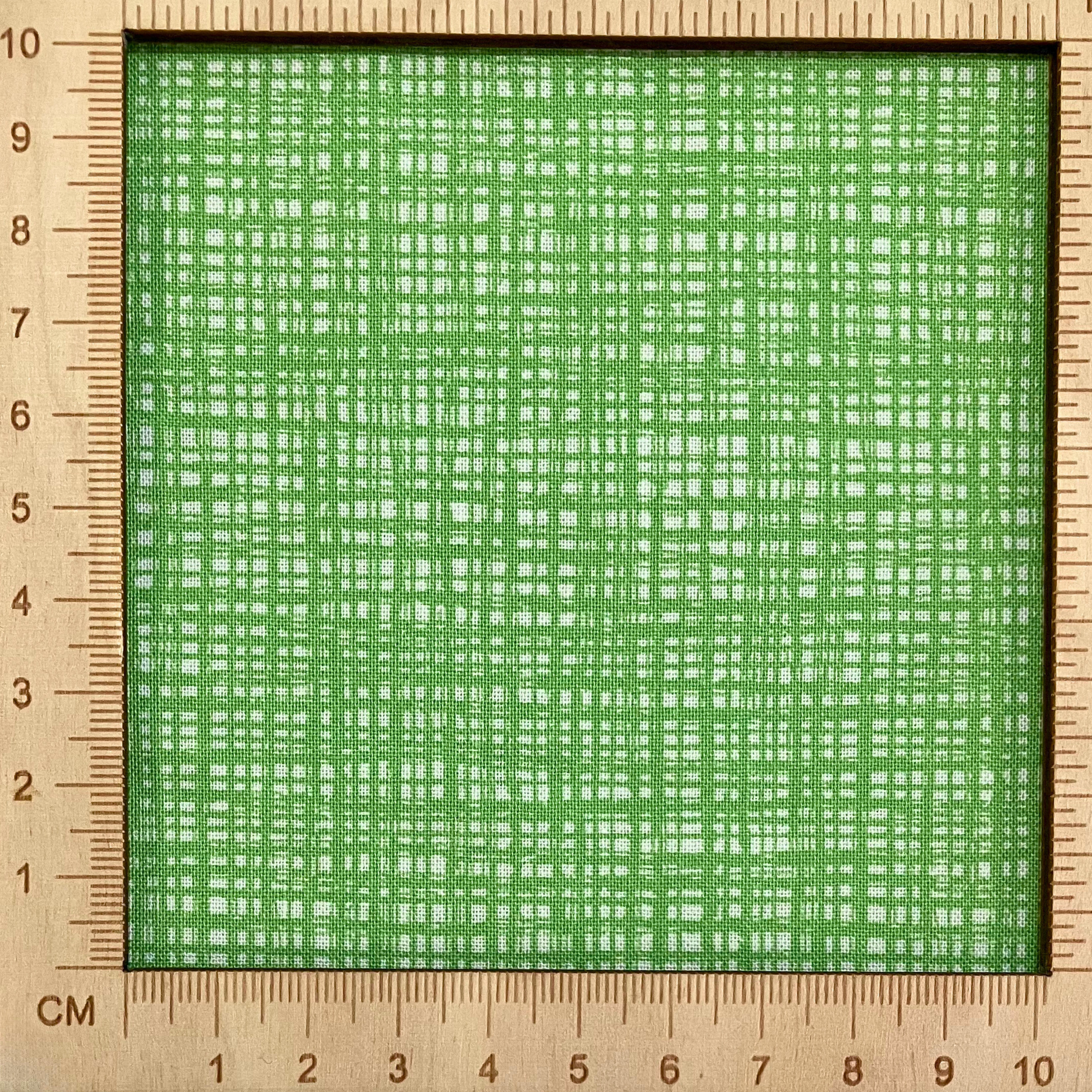 4"x4" scale — 100% cotton quilting fabric — Intersecting bright green lines. 43/44in width.