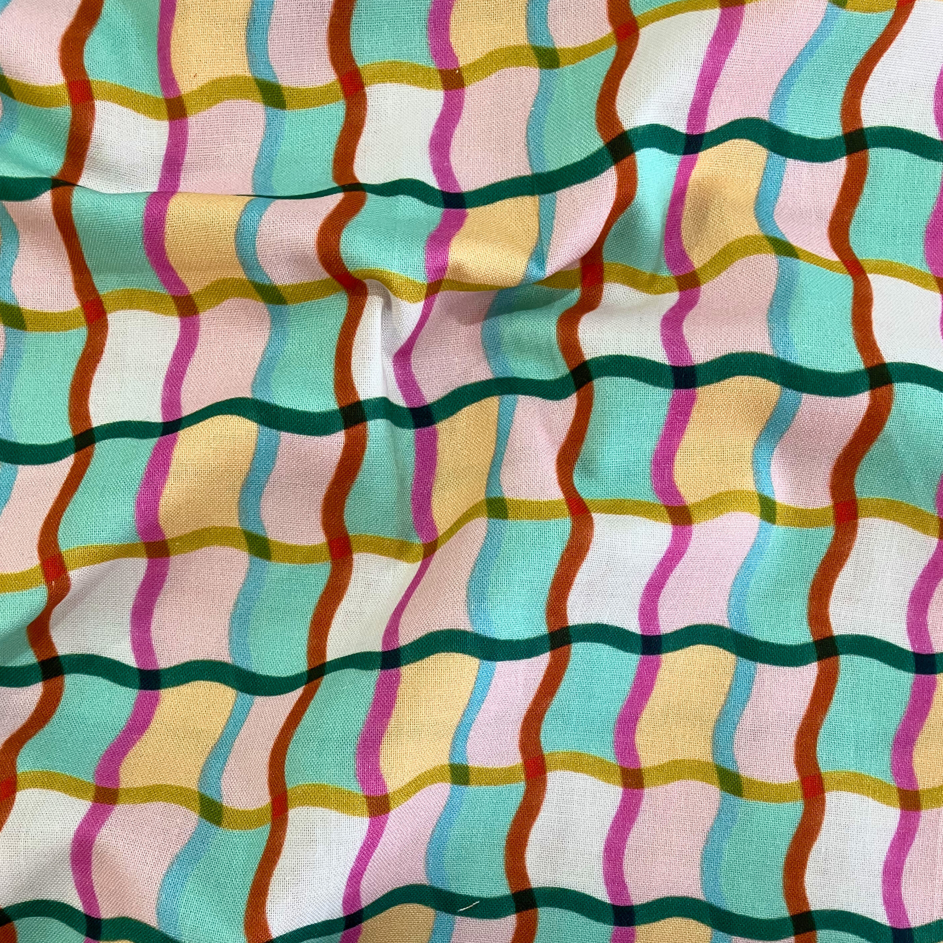 100% cotton quilting fabric — multicoloured wavy lines. 44in width.