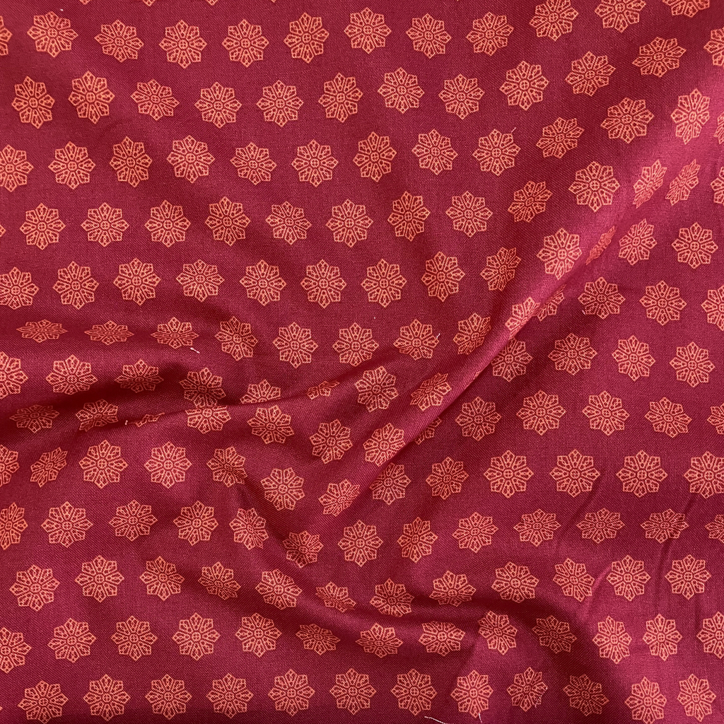 100% cotton quilting fabric — Terracotta geometric tile pattern on red. 44/45in width.