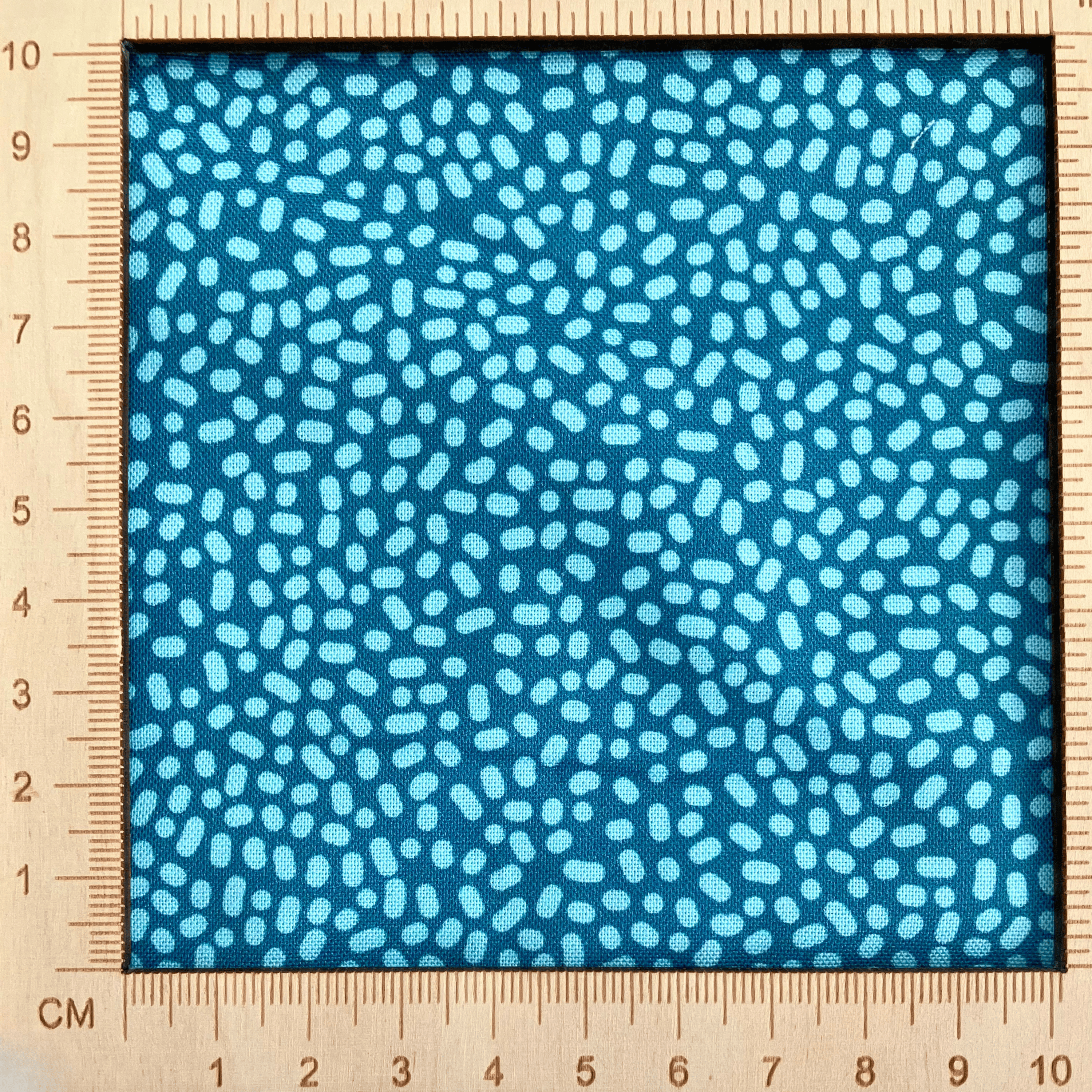 4"x4" scale — 100% cotton quilting fabric — Light green-blue dots on teal. 43/44in width.
