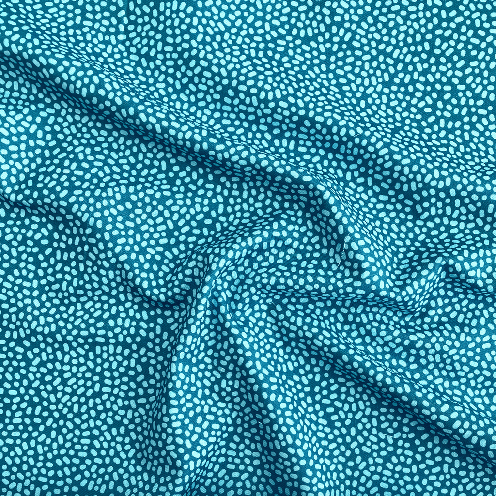 100% cotton quilting fabric — Light green-blue dots on teal. 43/44in width.