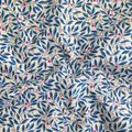 Liberty Fabrics Lasenby cotton — intertwining blue leafy branches with colourful beige and magenta berries. 44/45in width.