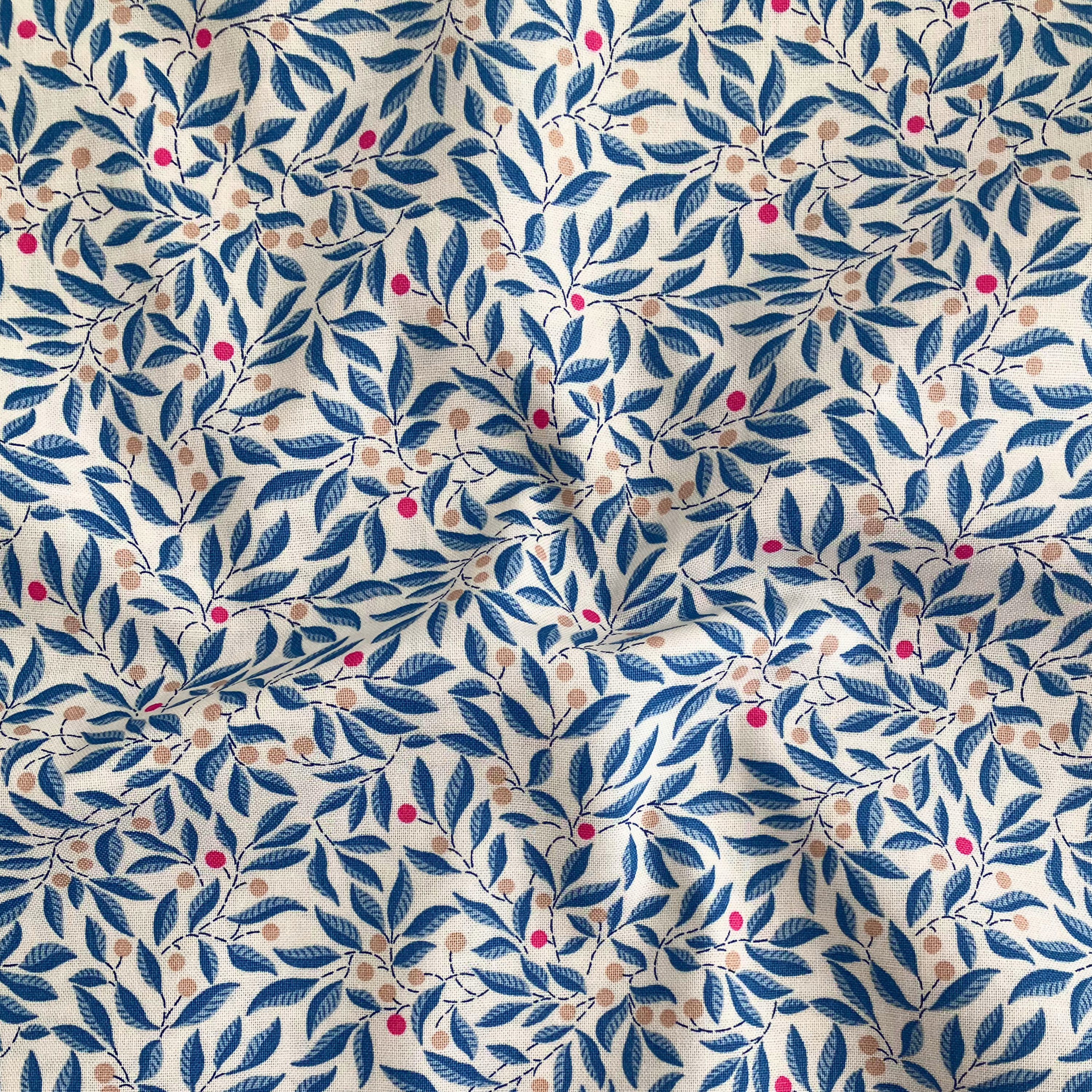 Liberty Fabrics Lasenby cotton — intertwining blue leafy branches with colourful beige and magenta berries. 44/45in width.