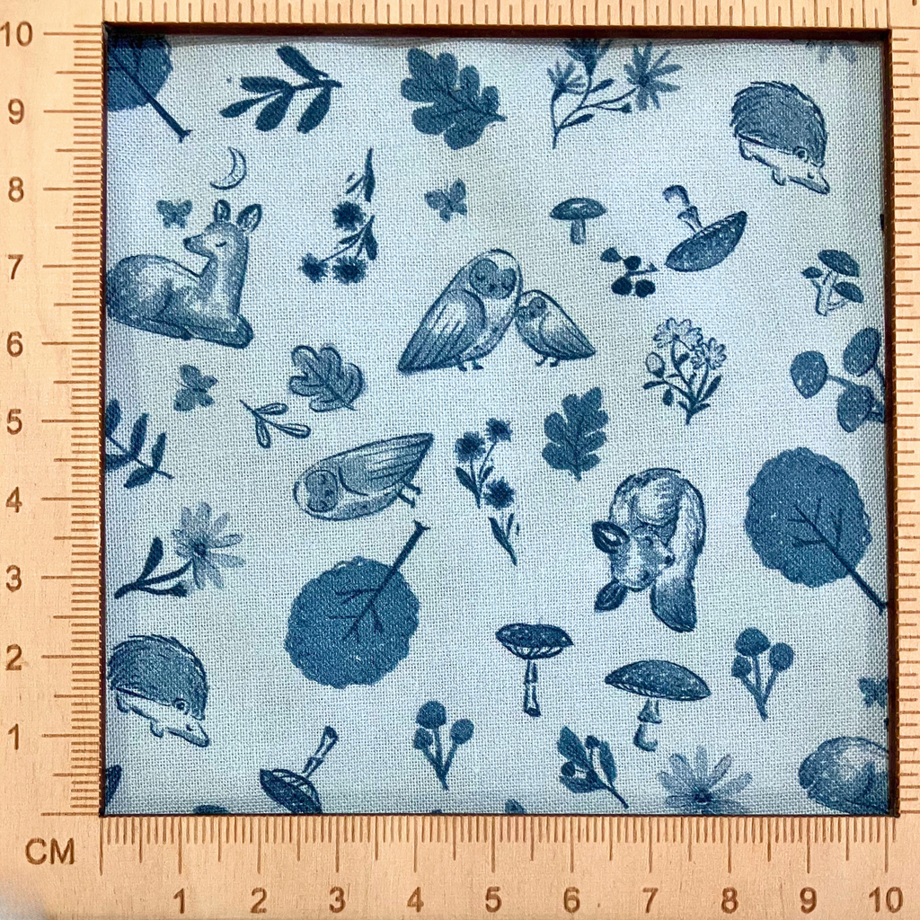 4"x4" scale — 100% cotton quilting fabric — grey deer, owls, mushrooms & trees on light grey-blue. 44/45in width.