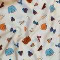 Woolens Toss quilting cotton — tossed toques, mittens, fair isle sweaters and winter botanicals in sky blue, burnt orange and brown on cream. Art Gallery Fabrics, 44/45″ wide.